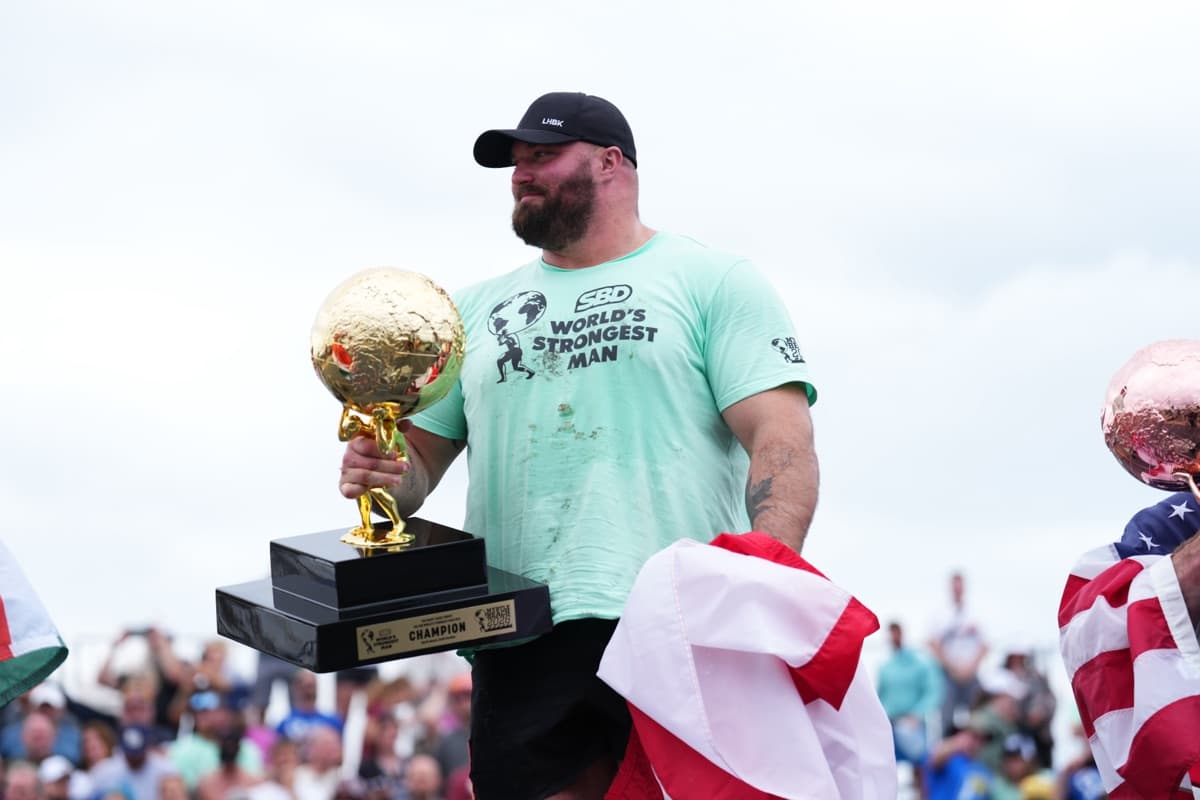 Mitchell Hooper holding the 2026 World's Strongest Man trophy